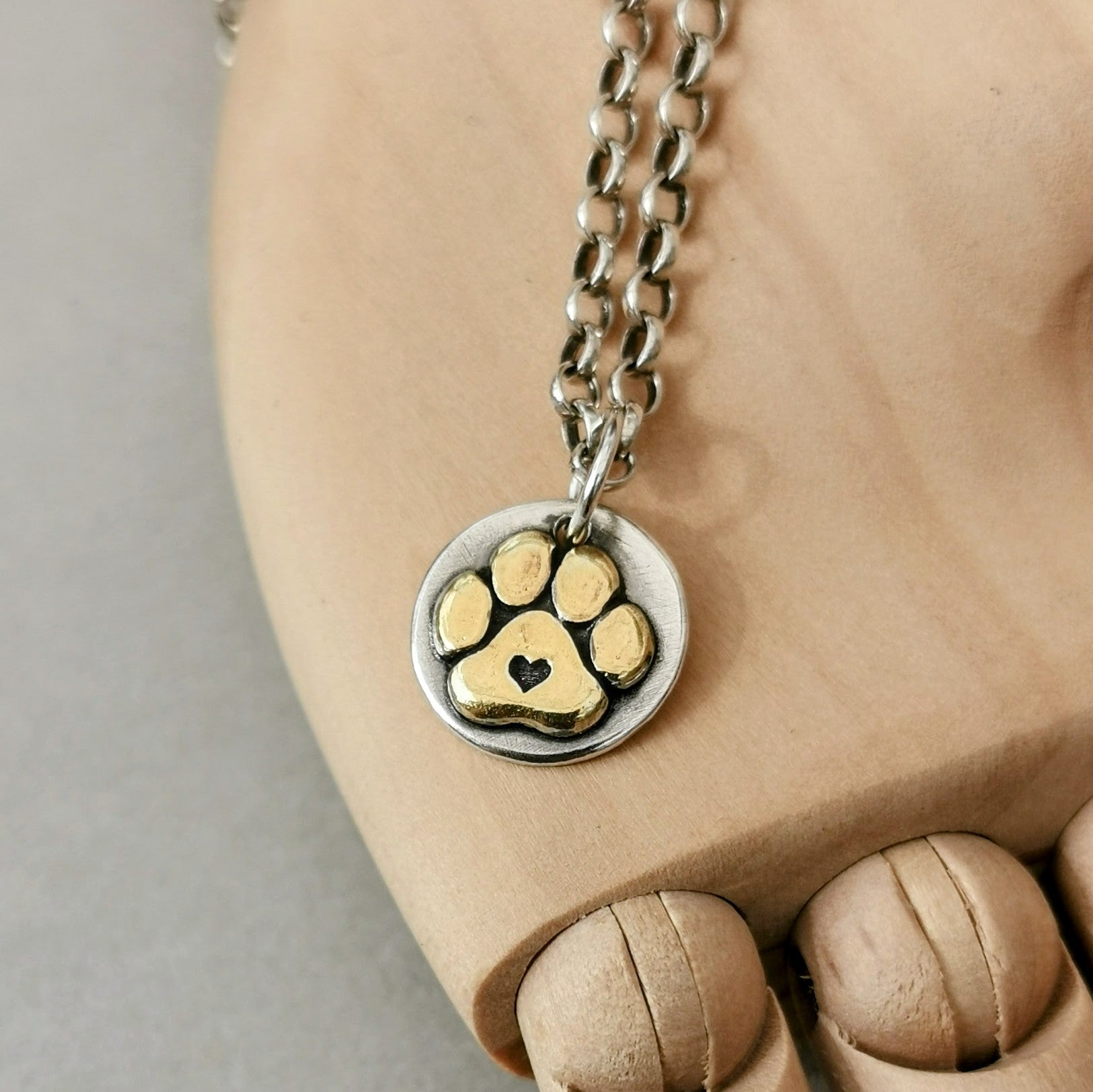 Handgefertigter Kettenanhänger aus recyceltem Silber, vergoldete Hundepfote mit Herz, Symbol für Pfotenliebe, personalisierbar mit Gravur.
