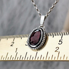 handgefertigter Kettenanhänger aus recyceltem Silber mit Granat und individueller Gravur.